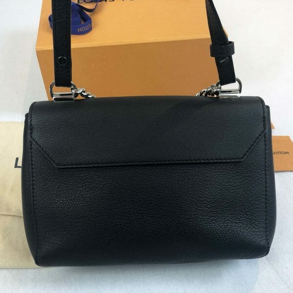 Louis Vuitton lock me bb bag in black with silver lock back of bag